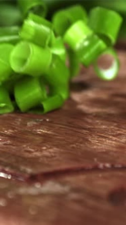 The Chopped Green Onions Fall Onto the Cutting Board Filmed on a Highspeed Camera at 1000 Fps