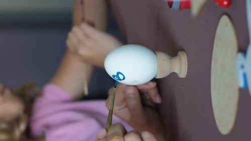 Child Painting Easter Egg With Flowers