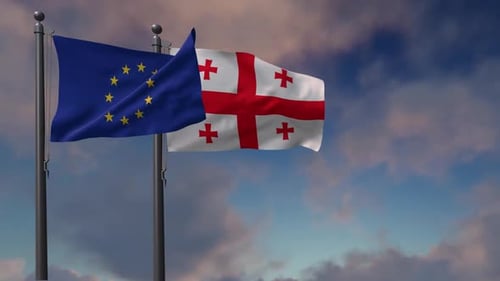 European Union and Georgia Flags Waving Against Cloudy Sky