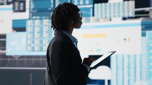 Woman Using Tablet to Compare Company KPIs Data