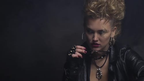 Stylish Woman with Blonde Hair Puts on Sunglasses