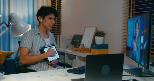 Young Adult on Video Call with Tablet in Office