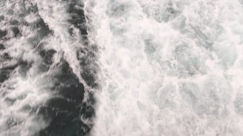 Close up of a boat wake. Water rough and turbulent current waves