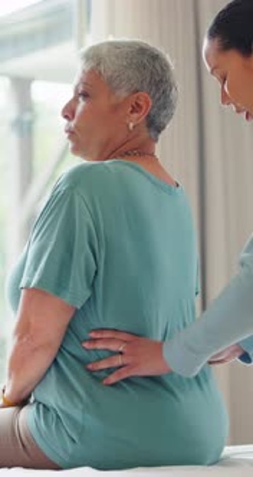 Office, senior woman and chiropractor with back rehabilitation, conversation and pain