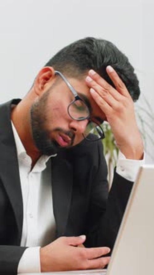 Tired Indian Business Man Suffering From Headache Problem Tension Migraine Stress at Home Office