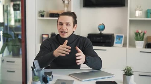 Energetic Young Adult Man Presenting at Desk
