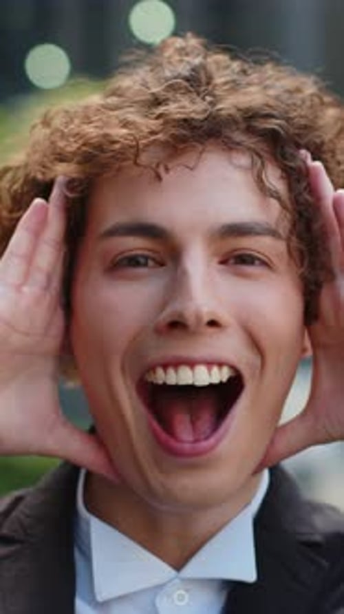 Businessman Looking at Camera Shocked By Sudden Victory Game Winning Good News Outside Office