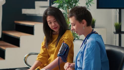 Medical Worker Checks Blood Pressure of Adult Woman