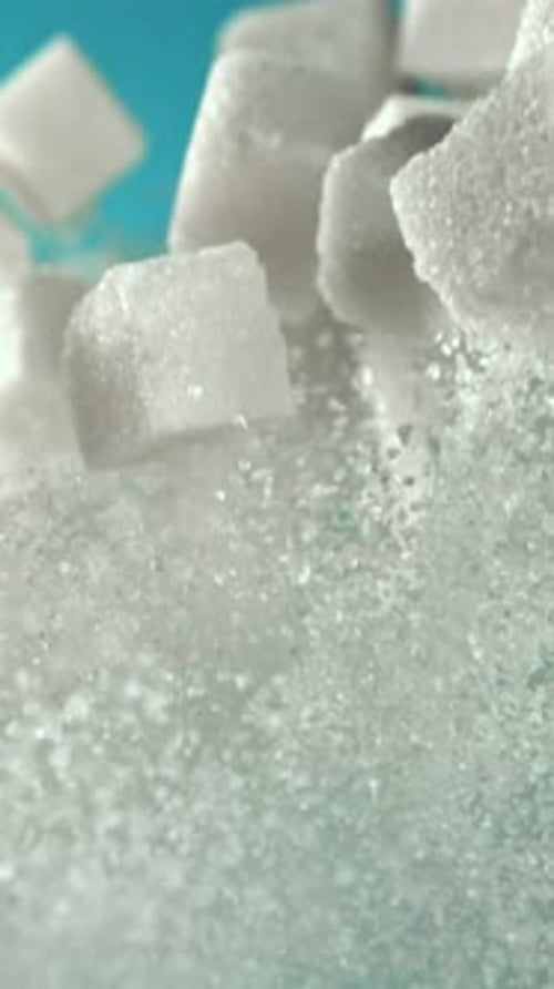 Cubes of Sugar Fly Up and Fall Down on a Blue Background Filmed on a Highspeed Camera at 1000 Fps