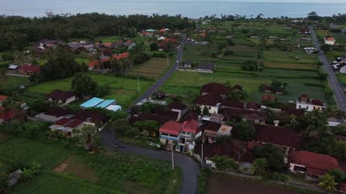 Drone aerial circle fly above tropical suburb residential empty street