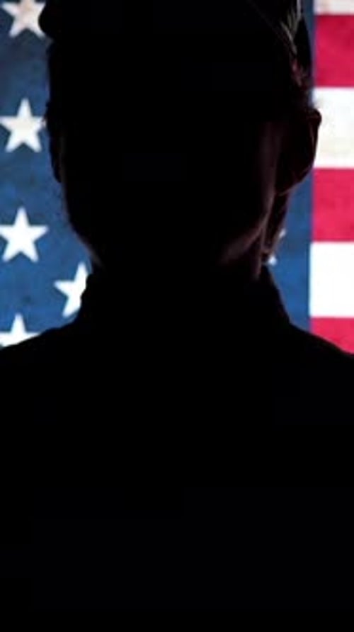 A Soldier Salutes Against the Background of the Flag US Soldiers US Army