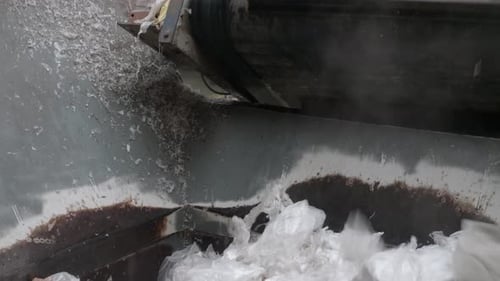 Plastic Shredder At Recycling Plant. Plastic Waste Moving on a Conveyor Machine.