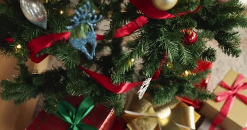 Christmas, tree or bauble with gifts, decor or lights for festive or December holiday celebration