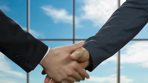 Businessmen Shake Hands in Office