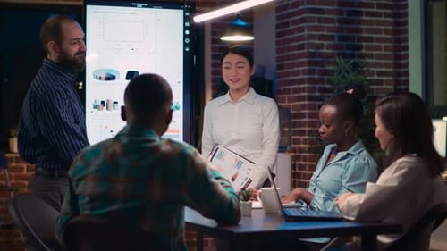 Diverse Team Discussing Business Strategy at Night