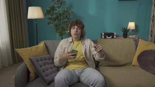 Young Adult Dancing and Listening to Music at Home