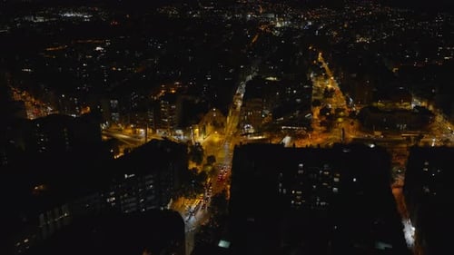 Aerial Shot of City at Night Low Traffic in Illuminated Streets and Intersections in Urban