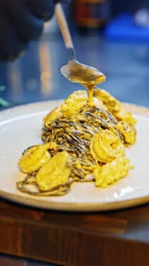 Chef Drizzles Sauce on Gourmet Pasta Dish