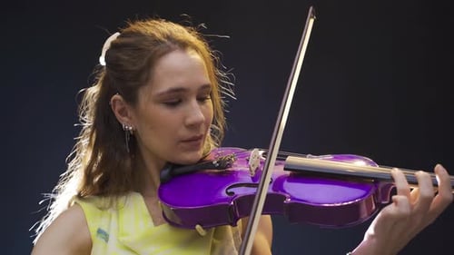 Woman Plays Purple Electric Violin Close Up