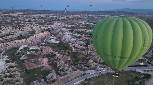 Hot Air Balloons Fly Over the Mountainous Landscape of Cappadocia Turkey