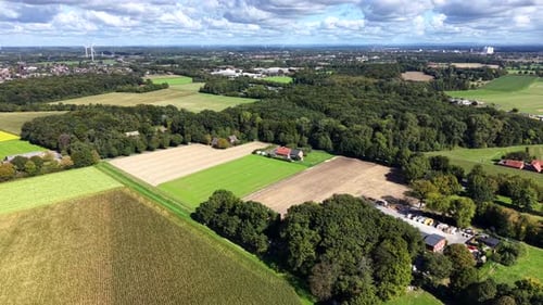 Peaceful landscape with colored green trees and farmland fields in US. Cloudy and sunny day in