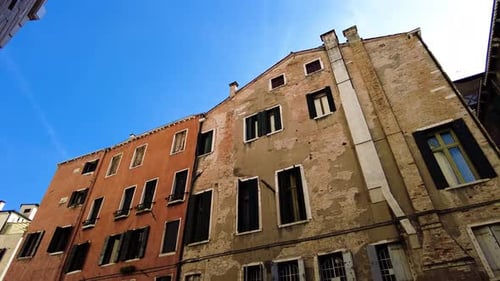 Slowly Deteriorated Walls Of Old Buildings In The Narrow Streets Of Venice, Italy. Low Angle Shot