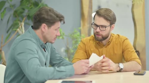 Business People Discussing Paperwork in Office