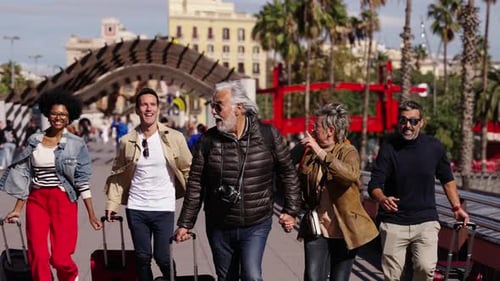 Group of Middleaged Diverse Tourist People Running with Their Luggage Down the Street