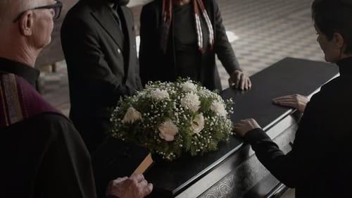 Mourners Gather Around Casket in Remembrance