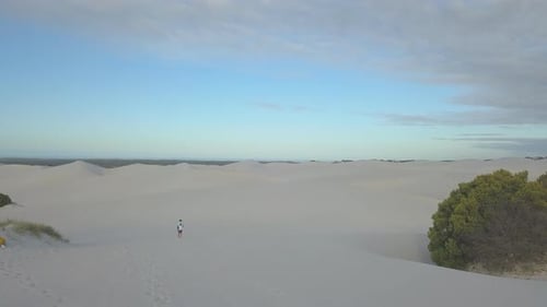 Aerial of man hiking on sand dunes in South Africa