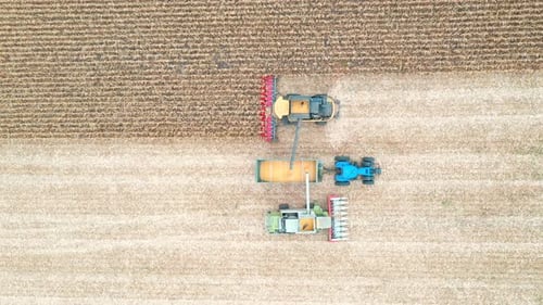 Harvesters Gathering Crops in Rural Farmland, Aerial View