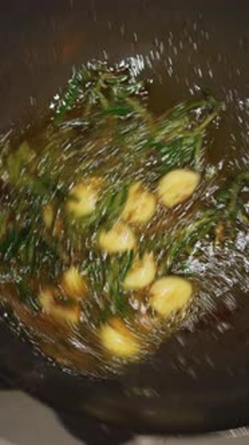 Cooking Garlic and Rosemary in a Pan