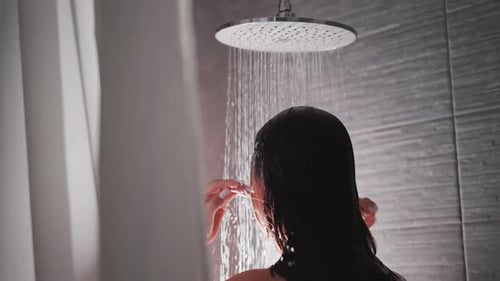 Woman Showering Under Modern Rainfall Shower Head