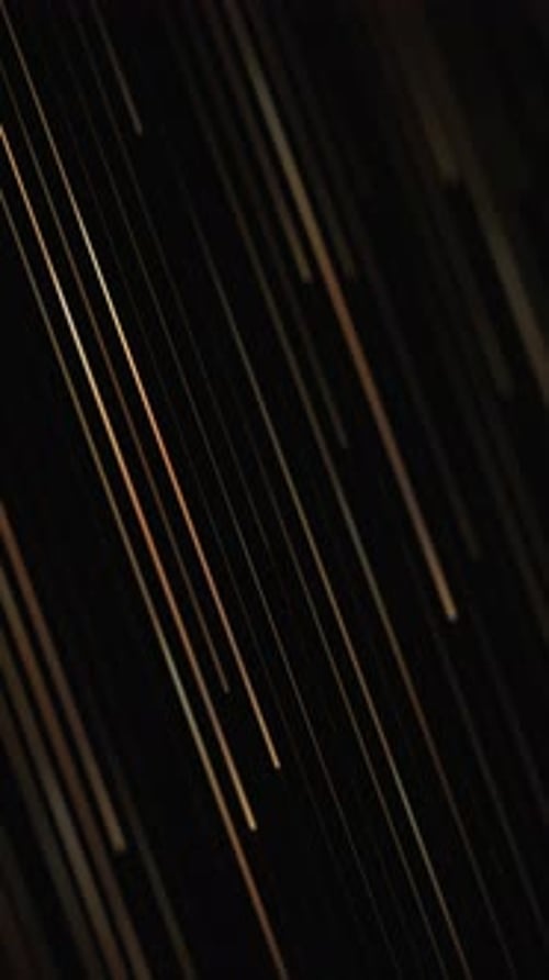 Golden diagonal light streaks drifting across deep black space. Elegant metallic beams forming subtl