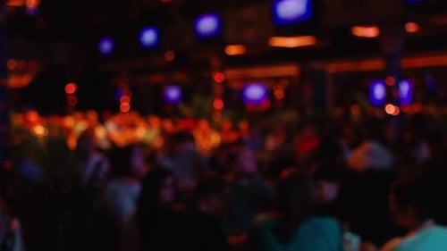 Blurred Interior with People at Tables at Night