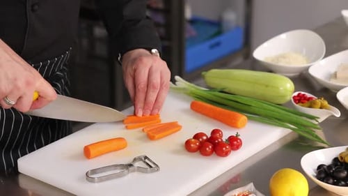 Chef Slices Carrots in Commercial Kitchen