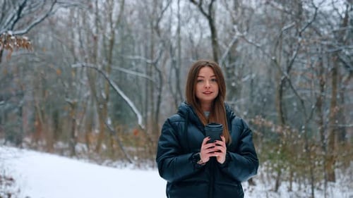 Woman With Coffee in Winter Snowy Forest