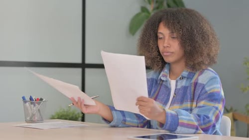 Young Woman Reviews Documents in an Office
