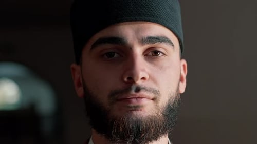 Portrait of a Muslim man praying on his knees in Ramadan and giving thanks for support and spiritual