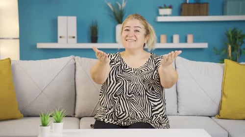 Smiling Woman Clapping her Hands on Couch