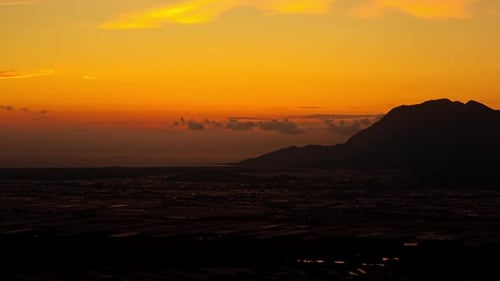 Sunset Time-Lapse Over City and Mountain