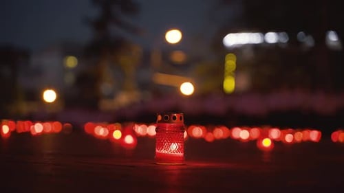 Candle Lanterns Lit on Ground at Night