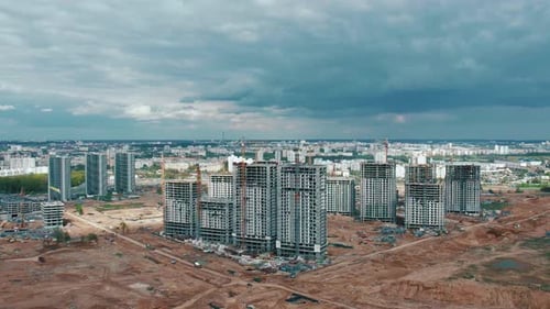 Aerial View of the Construction of Highrise Buildings in New Microdistrict with a Crane and Panorama