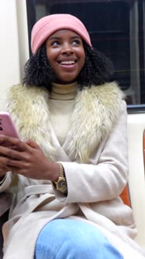 Young Woman Using Smartphone on Subway Train
