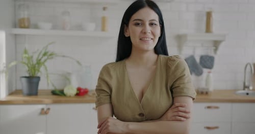 Smiling Brunette Woman Posing in Kitchen