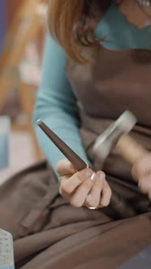 Woman Jeweller Hammering A Ring At Her Workshop Place Close Up