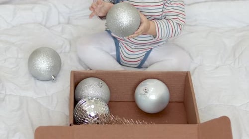 Adorable Baby Plays with Christmas Tree Ornaments