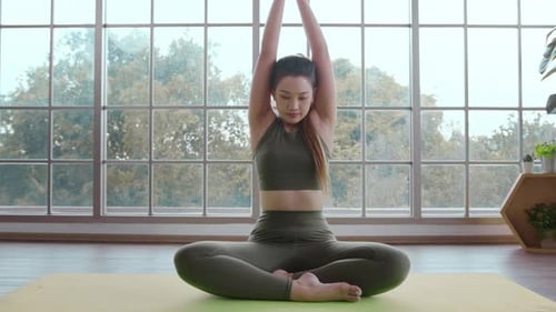 Young Woman Meditating While Doing Yoga