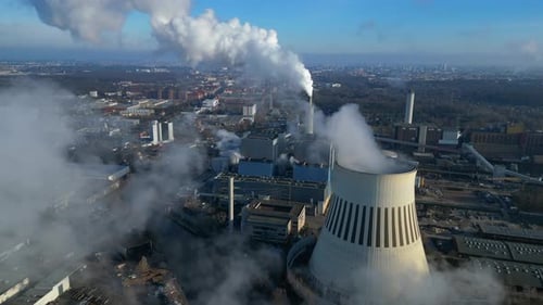 Thermal power plant factory emitting smoke over city. Lovely aerial view flight drone