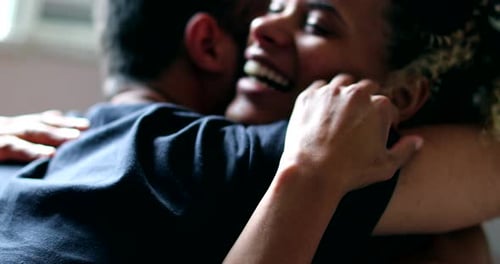 Smiling Couple Embraces Affectionately Indoors in Close Up